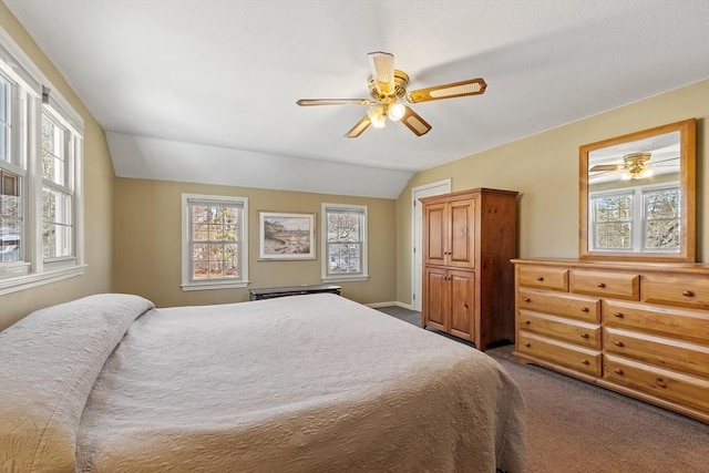 bedroom with a ceiling fan, lofted ceiling, multiple windows, and carpet