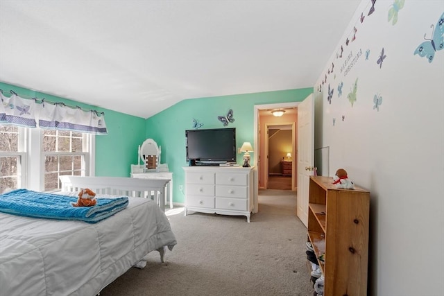 bedroom with lofted ceiling and carpet flooring