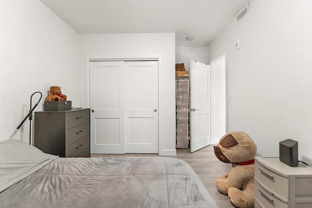 bedroom featuring light wood-type flooring and a closet