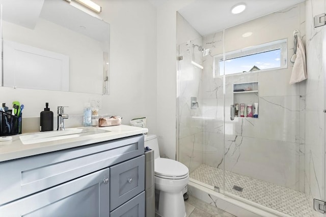 bathroom featuring an enclosed shower, vanity, and toilet