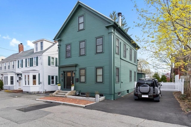 view of front of house featuring fence