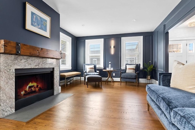living area with a premium fireplace and wood finished floors