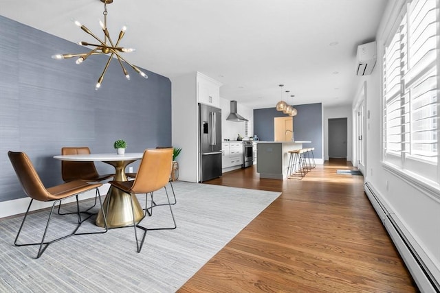 dining space featuring an inviting chandelier, baseboards, a wall unit AC, a baseboard heating unit, and dark wood finished floors