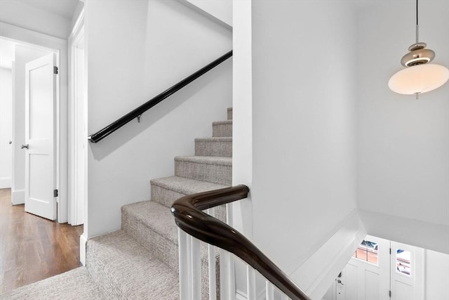 staircase with wood finished floors