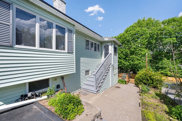 18 Gordon St, Worcester, MA 01604 - view of side of property with stairway and a chimney