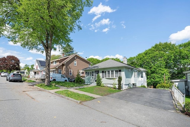 18 Gordon St, Worcester, MA 01604 - view of front of house featuring a chimney and asphalt driveway