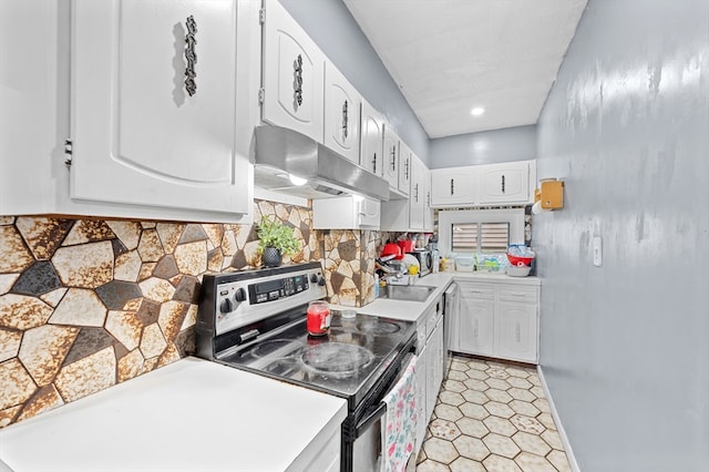 18 Gordon St, Worcester, MA 01604 - kitchen with electric stove, under cabinet range hood, white cabinets, light countertops, and recessed lighting
