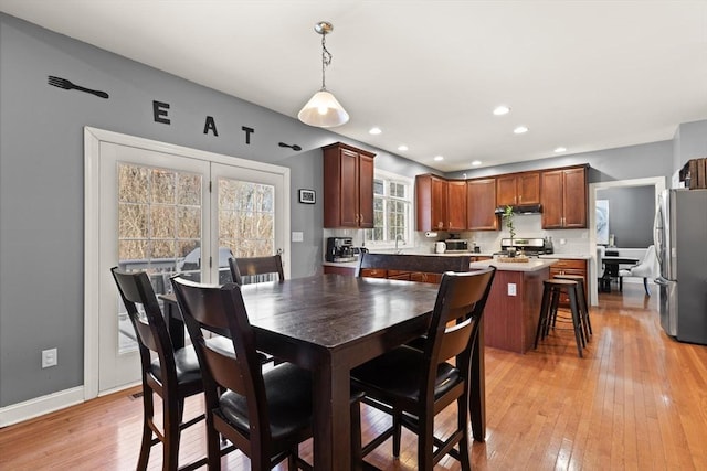 dining room featuring light wood-type flooring and sink