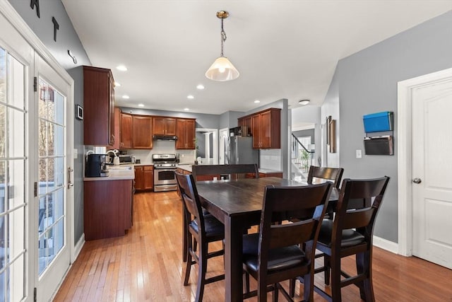 dining room featuring light hardwood / wood-style flooring and a healthy amount of sunlight