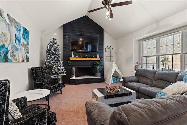 carpeted living room featuring ceiling fan, a large fireplace, and vaulted ceiling