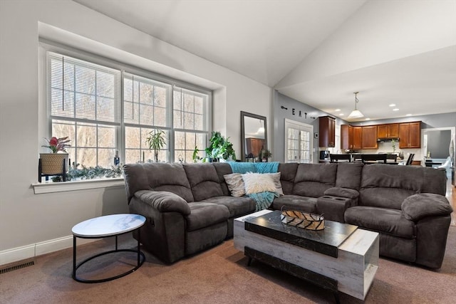 carpeted living room with vaulted ceiling