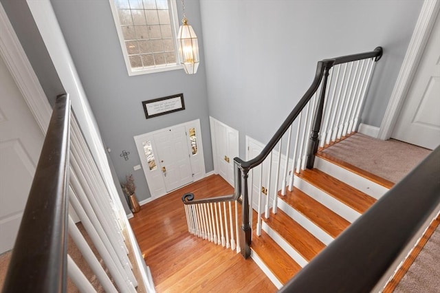 stairway with hardwood / wood-style floors