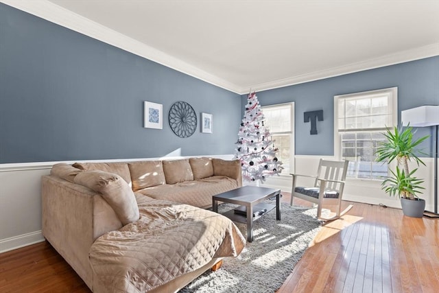 living room with wood-type flooring and ornamental molding