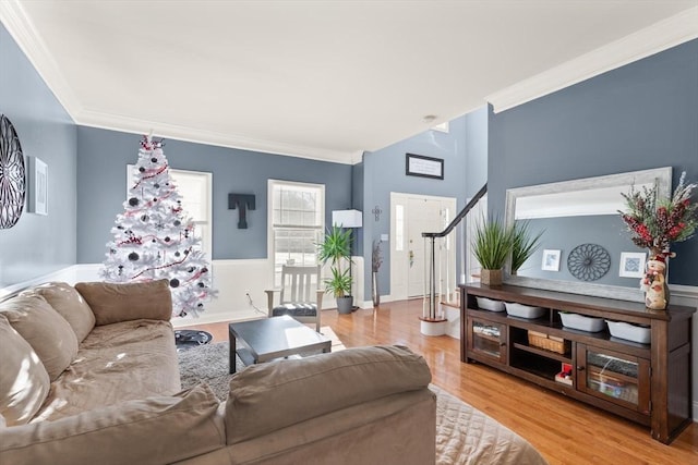 living room with light wood-type flooring and crown molding