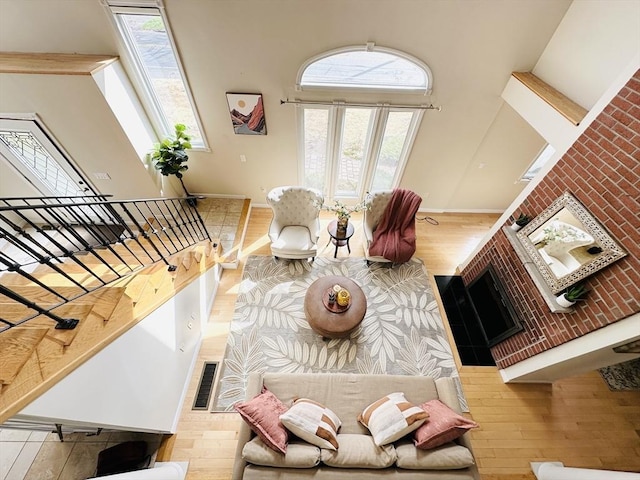 living room featuring hardwood / wood-style floors, crown molding, and a healthy amount of sunlight