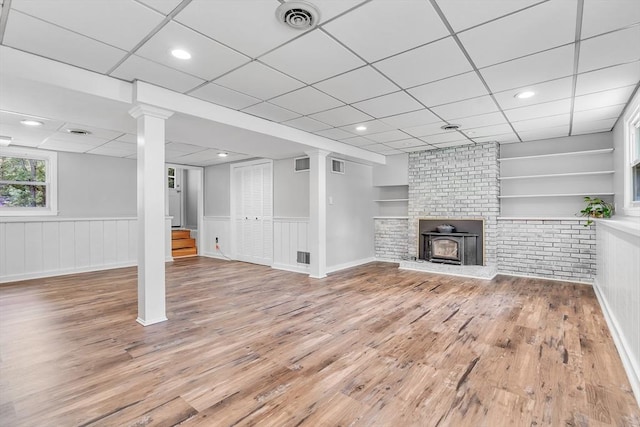 2 Walker St, Norton, MA 02766 - unfurnished living room featuring a drop ceiling, light wood-type flooring, stairway, and wainscoting