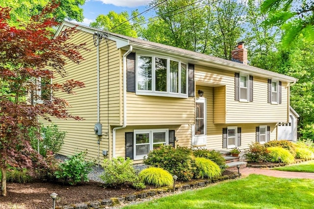 2 Walker St, Norton, MA 02766 - raised ranch featuring a chimney and a front yard