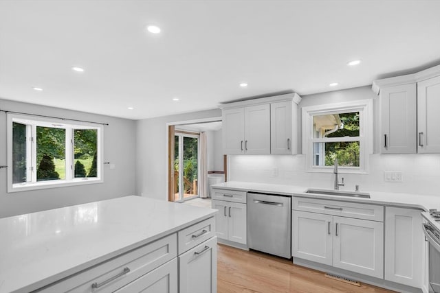 2 Walker St, Norton, MA 02766 - kitchen with dishwasher, a sink, decorative backsplash, light wood finished floors, and recessed lighting