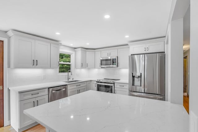 2 Walker St, Norton, MA 02766 - kitchen featuring stainless steel appliances, a sink, backsplash, light stone counters, and recessed lighting