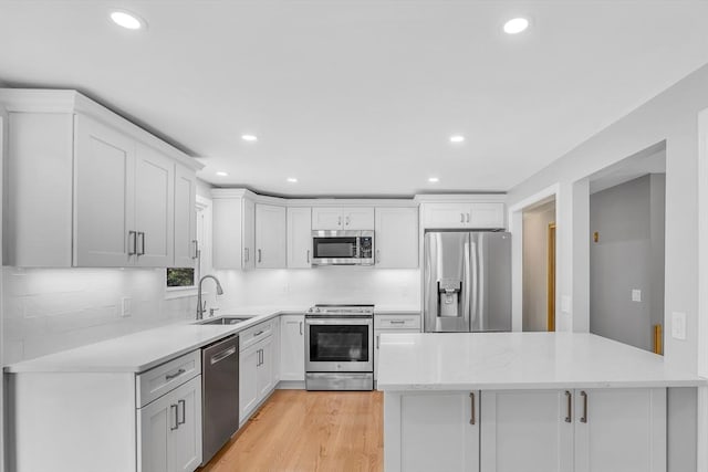 2 Walker St, Norton, MA 02766 - kitchen with appliances with stainless steel finishes, a sink, recessed lighting, white cabinetry, and backsplash