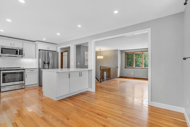2 Walker St, Norton, MA 02766 - kitchen featuring appliances with stainless steel finishes, light wood-type flooring, light countertops, white cabinets, and recessed lighting
