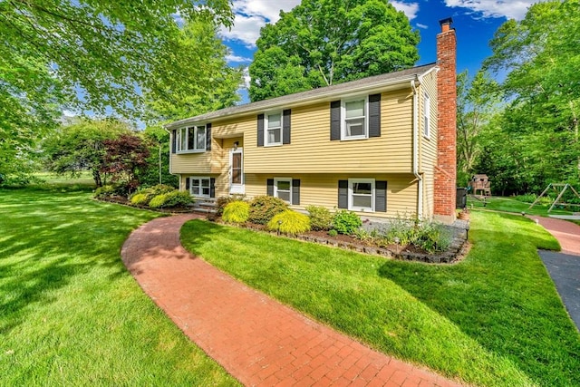 2 Walker St, Norton, MA 02766 - split foyer home with a chimney, a playground, and a front lawn