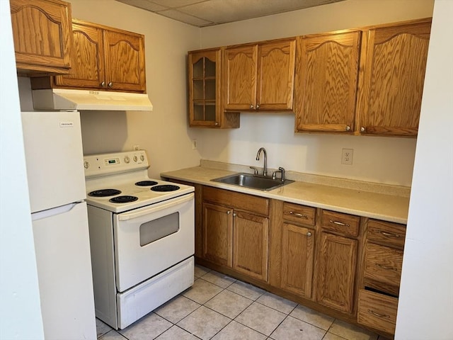 kitchen with light tile patterned flooring, sink, and white appliances