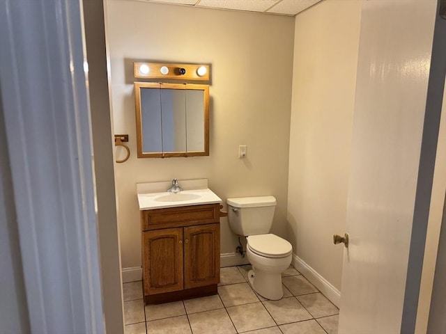 bathroom featuring tile patterned flooring, vanity, and toilet