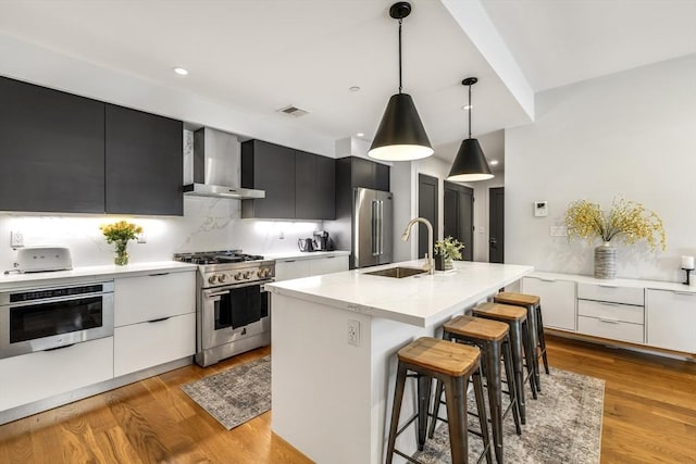 531-533 E 2nd St Unit 202, Boston, MA 02127 - kitchen featuring premium appliances, wall chimney exhaust hood, modern cabinets, a sink, and recessed lighting