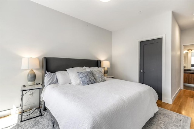 531-533 E 2nd St Unit 202, Boston, MA 02127 - bedroom featuring wood finished floors, baseboards, and connected bathroom