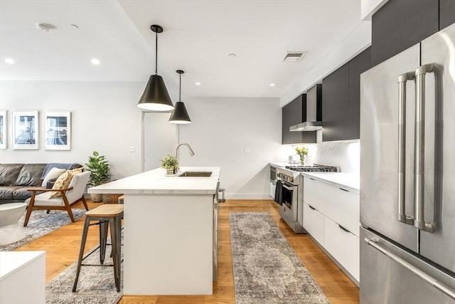531-533 E 2nd St Unit 202, Boston, MA 02127 - kitchen with premium appliances, modern cabinets, light countertops, wall chimney exhaust hood, and a sink