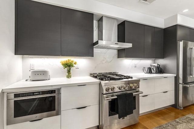 531-533 E 2nd St Unit 202, Boston, MA 02127 - kitchen featuring appliances with stainless steel finishes, wall chimney exhaust hood, modern cabinets, and recessed lighting