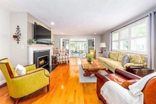 19 Longwood Rd Unit 243, Mashpee, MA 02649 - living area featuring a fireplace with flush hearth, plenty of natural light, wood finished floors, and recessed lighting