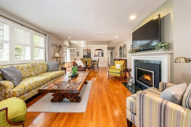 19 Longwood Rd Unit 243, Mashpee, MA 02649 - living area with hardwood / wood-style flooring, a high end fireplace, a chandelier, and recessed lighting