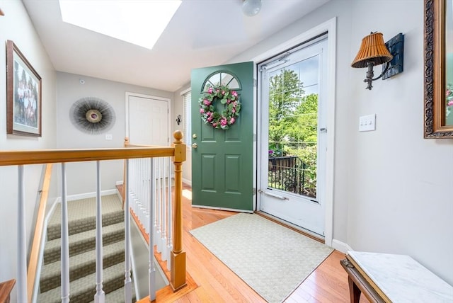 19 Longwood Rd Unit 243, Mashpee, MA 02649 - entryway featuring a skylight, light wood finished floors, and baseboards