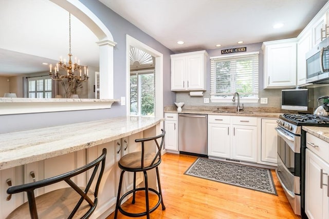 19 Longwood Rd Unit 243, Mashpee, MA 02649 - kitchen featuring appliances with stainless steel finishes, a sink, plenty of natural light, tasteful backsplash, and recessed lighting