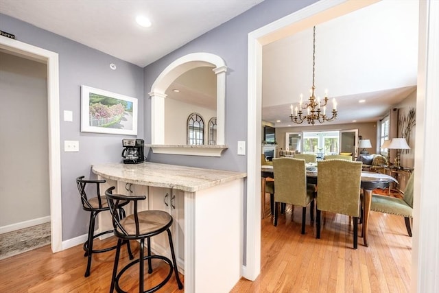 19 Longwood Rd Unit 243, Mashpee, MA 02649 - dining area with light wood-style floors, recessed lighting, a chandelier, baseboards, and arched walkways