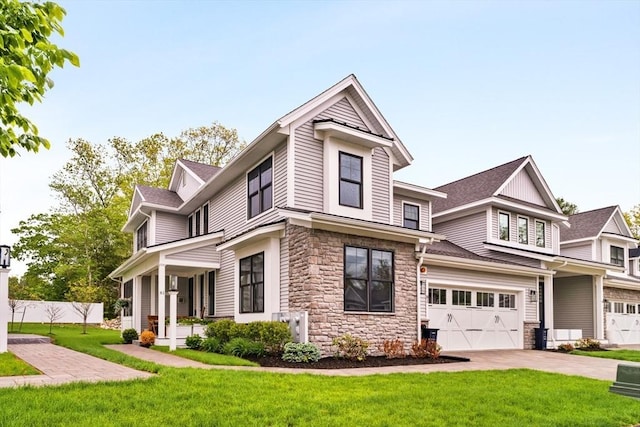 81 Rowell Ln Unit 81, Middleton, MA 01949 - view of front facade with stone siding, concrete driveway, and a garage