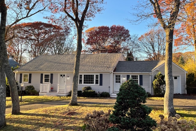 single story home with a garage and a front lawn