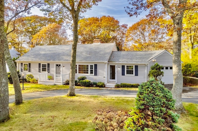 ranch-style home with a garage and a front lawn