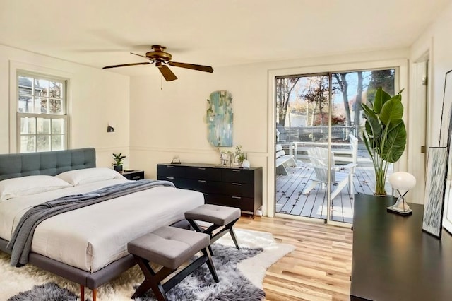 bedroom featuring ceiling fan, multiple windows, light wood-type flooring, and access to outside