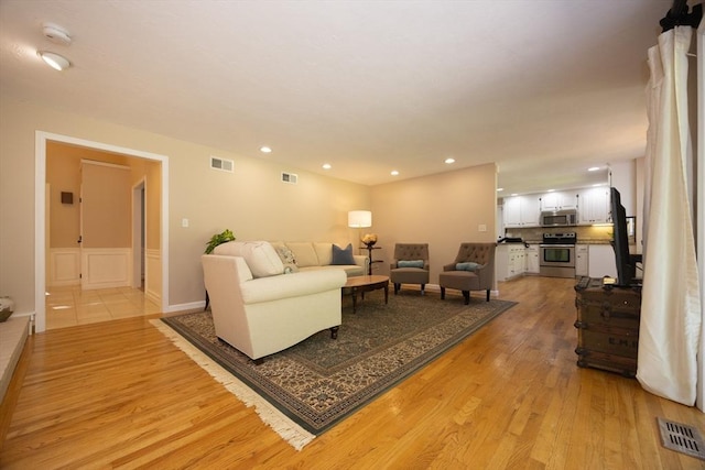 13 Valleywood Rd, Hopkinton, MA 01748 - living room featuring light wood-style floors, recessed lighting, and a wainscoted wall