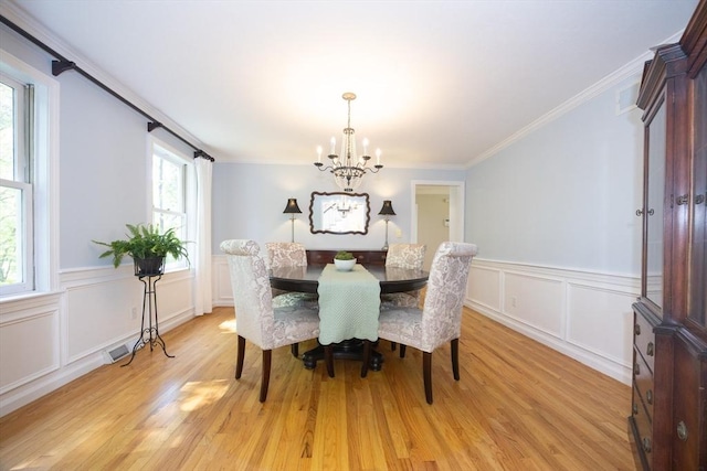 13 Valleywood Rd, Hopkinton, MA 01748 - dining space with a chandelier, light wood-style flooring, wainscoting, crown molding, and a decorative wall