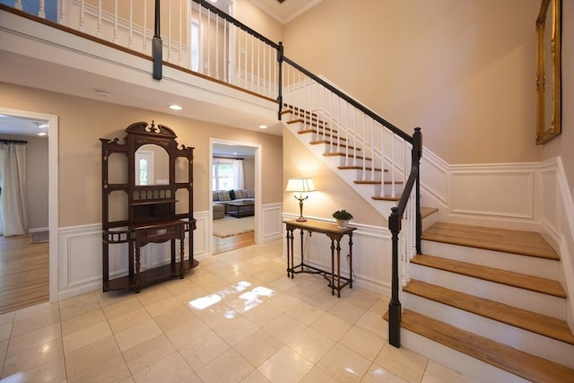 13 Valleywood Rd, Hopkinton, MA 01748 - staircase featuring a decorative wall, tile patterned flooring, and a wainscoted wall