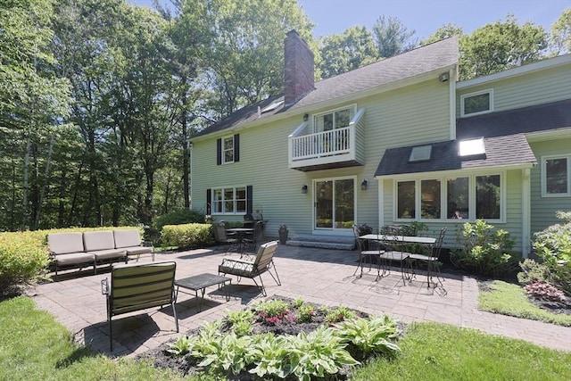 13 Valleywood Rd, Hopkinton, MA 01748 - back of property featuring an outdoor living space, a chimney, a balcony, and a patio
