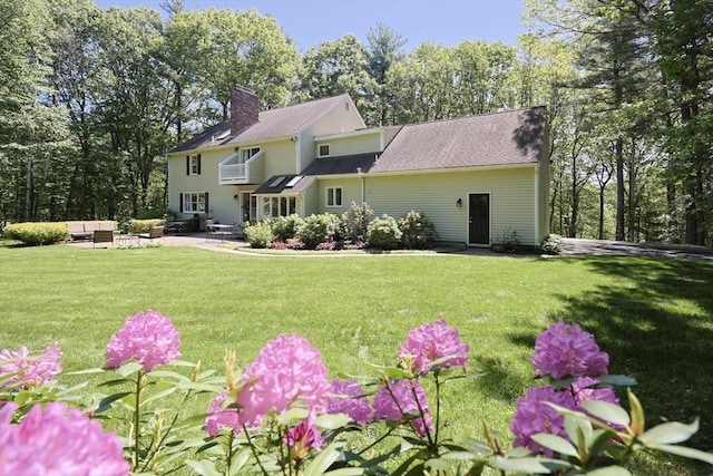 13 Valleywood Rd, Hopkinton, MA 01748 - rear view of house featuring an outdoor living space, a patio, a chimney, and a yard