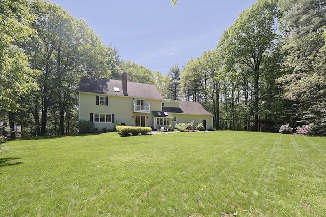 13 Valleywood Rd, Hopkinton, MA 01748 - rear view of house featuring a chimney and a lawn