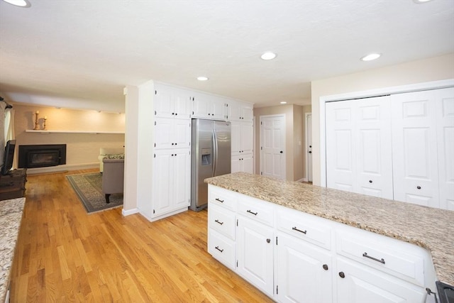 13 Valleywood Rd, Hopkinton, MA 01748 - kitchen with stainless steel fridge with ice dispenser, light wood-type flooring, white cabinets, recessed lighting, and light stone countertops