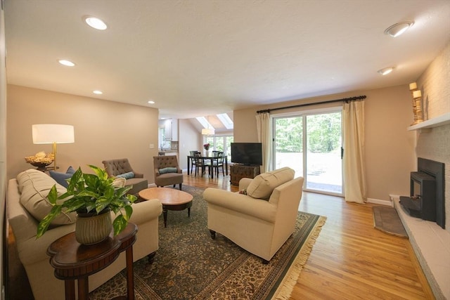 13 Valleywood Rd, Hopkinton, MA 01748 - living area featuring a fireplace with raised hearth, light wood-type flooring, recessed lighting, and baseboards