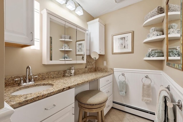 9 New Meadow Rd, Lynnfield, MA 01940 - bathroom featuring a baseboard heating unit, wainscoting, vanity, and tile patterned floors